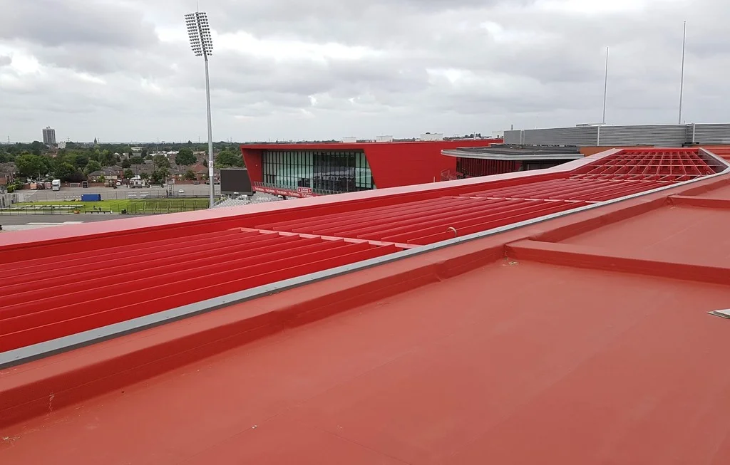 Červená střecha hotelu Hilton Garden Inn s fólií Protan SE a výhledem na okolní budovy stadionu Old Trafford Cricket Ground v Manchesteru